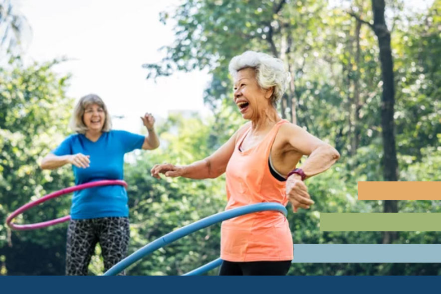Two elderly women smiling while hula hooping in a park, ROC Orthopedics