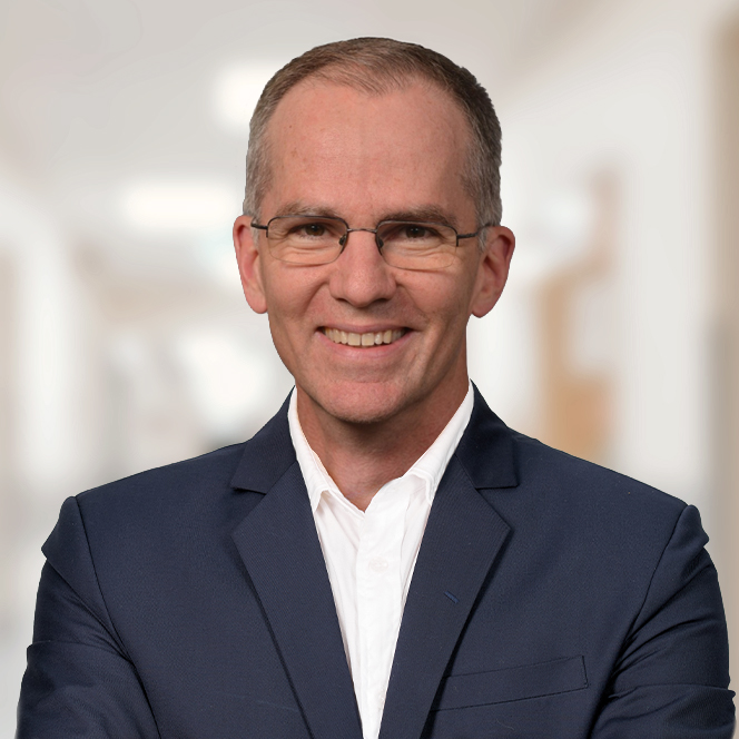 James Ballard smiling in headshot.