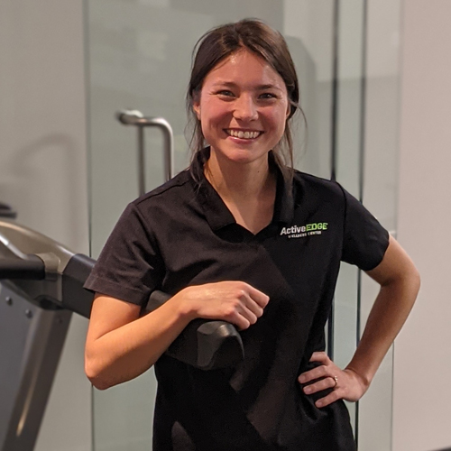A woman with blond hair in front of a white background.