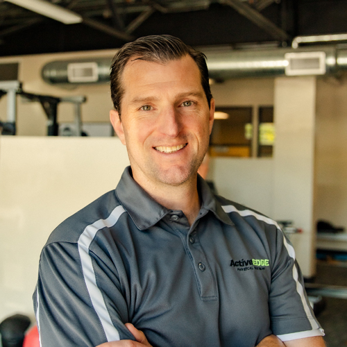 A woman with blond hair in front of a white background.