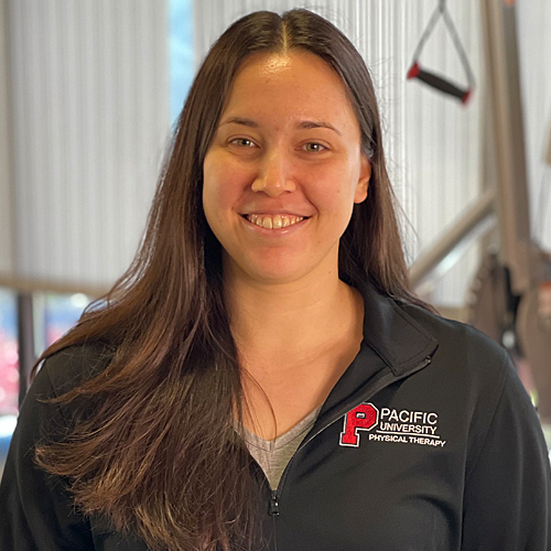 A woman with blond hair in front of a white background.