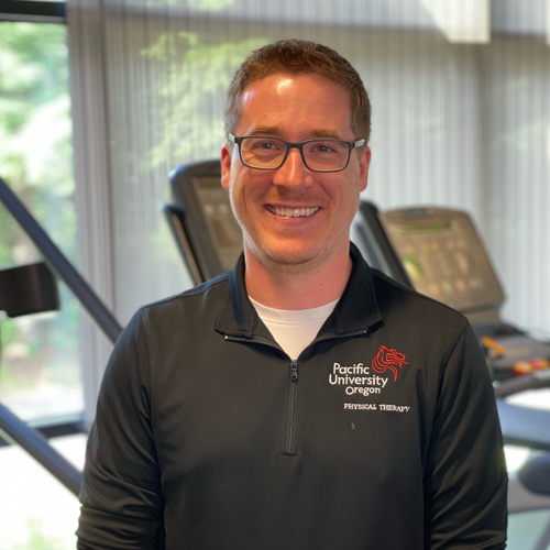 A woman with blond hair in front of a white background.