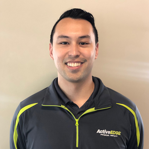 A woman with blond hair in front of a white background.